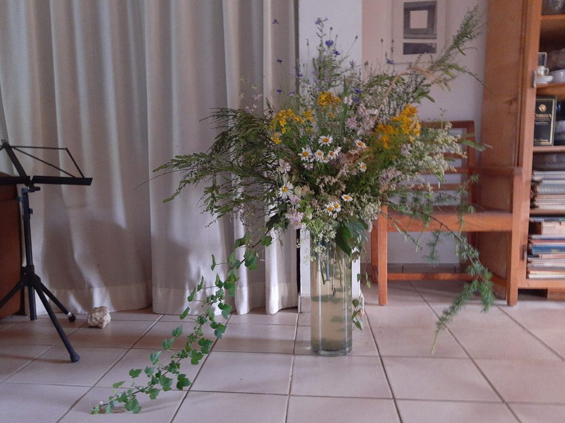 A finished arrangement of wildflowers styled in a vase